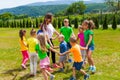 Schoolchildren with teacher have dance and sing lesson