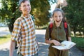 schoolchildren, a teenage boy and a girl are yawning, tired of studying and want to sleep, a city street on a summer day Royalty Free Stock Photo