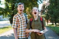 schoolchildren, a teenage boy and a girl are yawning, tired of studying and want to sleep, a city street on a summer day Royalty Free Stock Photo