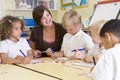 Schoolchildren and their teacher in a class Royalty Free Stock Photo