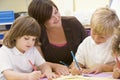 Schoolchildren and their teacher in a class Royalty Free Stock Photo