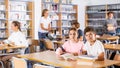 Schoolchildren write out a synopsis from the textbook Royalty Free Stock Photo