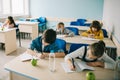 schoolchildren writing in notebooks on lesson Royalty Free Stock Photo