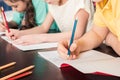 Schoolchildren writing with pencils Royalty Free Stock Photo