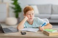 Schooler dreaming about something while doing homework Royalty Free Stock Photo