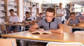 Schoolers reading in college library Royalty Free Stock Photo