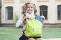 Schoolgirl with backpack relax outdoors, waiting school bus concept Royalty Free Stock Photo