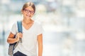 Schoolgirl with bag, backpack. Portrait of modern happy teen school girl with bag backpack. Girl with dental braces and glasses Royalty Free Stock Photo