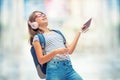 Schoolgirl with bag, backpack. Portrait of modern happy teen school girl with bag backpack headphones and tablet. Royalty Free Stock Photo