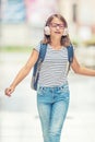 Schoolgirl with bag, backpack. Portrait of modern happy teen school girl with bag backpack headphones and tablet. Royalty Free Stock Photo