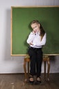 Schoolgirl with chalkboard in studio Royalty Free Stock Photo