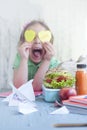 Schoolgirl cheerful at the table, textbooks, juice and toast for lunch.Copy cpace.