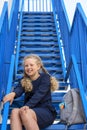 Schoolgirl climbs the stairs.