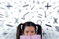 Composite image of schoolgirl covering mouth with book Royalty Free Stock Photo