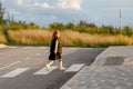 schoolgirl crosses the road at a pedestrian crossing Royalty Free Stock Photo