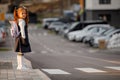 schoolgirl crosses the road at a pedestrian crossing Royalty Free Stock Photo