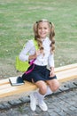 Schoolgirl cute child with backpack relax outdoors, formal education concept