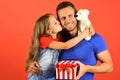 Schoolgirl and dad hold present box and white teddy bear. Royalty Free Stock Photo