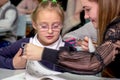 Schoolgirl at a desk with a woman teacher