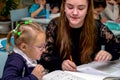 Schoolgirl at a desk with a woman teacher