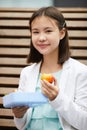 Schoolgirl eating fruit during break at school