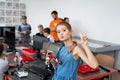 Schoolgirl girl in a robotics class, she holds a robot assembled from plastic parts