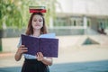 Schoolgirl girl teenager holds books on her head and reads a textbook with space for inscriptions. A large notebook in the hands Royalty Free Stock Photo