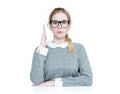 Schoolgirl in glasses raised her hand up, isolated on white background