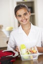 Schoolgirl With Healthy Lunchbox In Kitchen Royalty Free Stock Photo