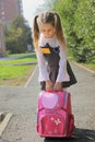 The schoolgirl with a heavy satchel