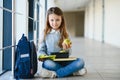 schoolgirl holding lunch box and apple going to eat Royalty Free Stock Photo