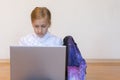 Schoolgirl with a laptop. the girl does exercises at a laptop. Girl with laptop on the floor. Back to school Royalty Free Stock Photo