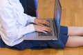 Schoolgirl with a laptop. the girl does exercises at a laptop. Girl with laptop on the floor. Back to school Royalty Free Stock Photo