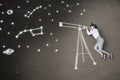 Schoolgirl laying on a asphalt, watching stars through a chalk-drawn telescope