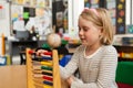 Schoolgirl learning mathematics with abacus in the classroom Royalty Free Stock Photo