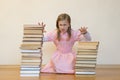 Schoolgirl is mad at books. The concept of hate to study and books. Unwillingness of a child to learn Royalty Free Stock Photo