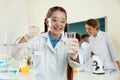 Schoolgirl making experiment in chemistry class