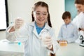 Schoolgirl making experiment in chemistry class