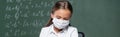 schoolgirl in medical mask near blurred