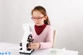 Schoolgirl with modern microscope Royalty Free Stock Photo