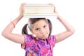 Schoolgirl with pile of books on head