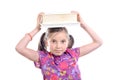 Schoolgirl with pile of books on head