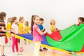 Schoolgirl playing parachute with friends in gym Royalty Free Stock Photo