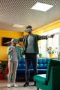 Schoolgirl playing in virtual reality with her teacher.