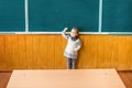 Schoolgirl points to an empty board Royalty Free Stock Photo