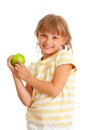 Schoolgirl portrait eating green apple isolated