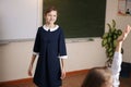 Schoolgirl posing in front of a blackboard Royalty Free Stock Photo