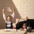 Schoolgirl with positive emotions and her sleeping tutor Royalty Free Stock Photo