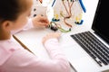 Schoolgirl programming robot with laptop computer at lesson Royalty Free Stock Photo