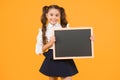 Schoolgirl pupil informing you. School girl hold blank chalkboard copy space. Announcement and promotion. Check this out